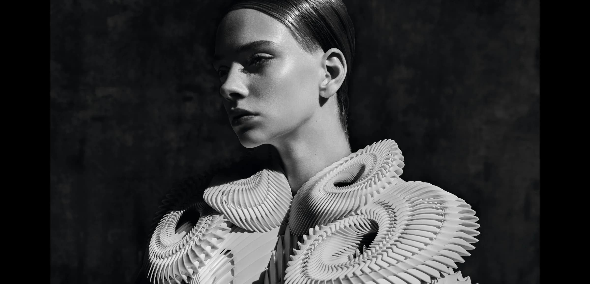 Artistic portrait of a figure in sculptural dress